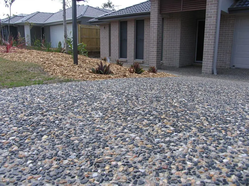 Exposed aggregate driveway with mixed river stone