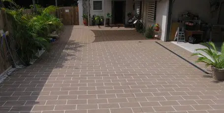 Brick-pattern stencilled concrete courtyard and entry