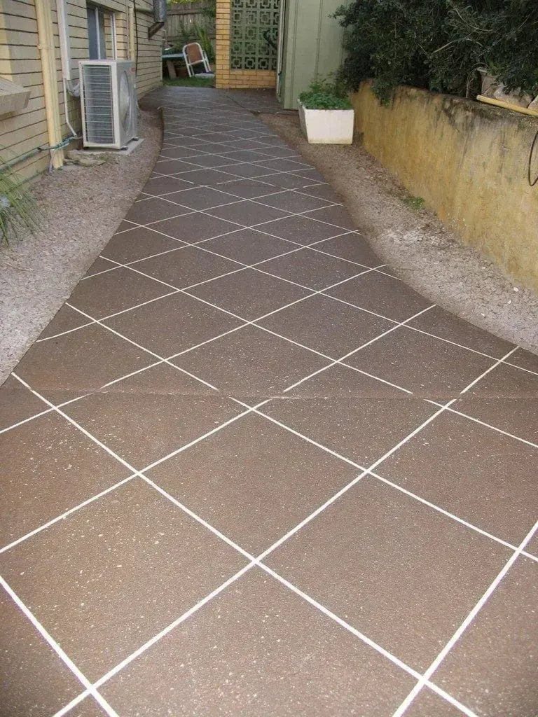 Side path resurfaced in brown fleck diamond tiles