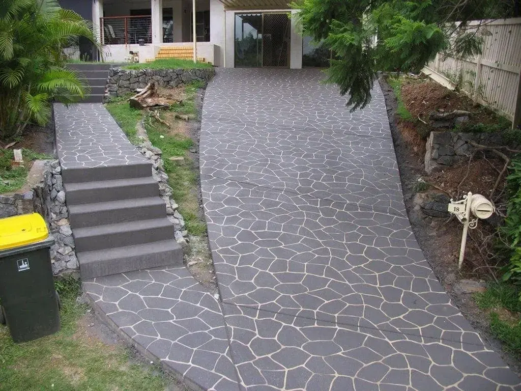 Sloping driveway, path and stairs resurfaced in a charcoal crazy-pave pattern