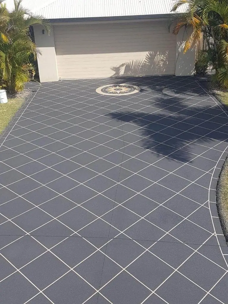 Charcoal diamond-tile driveway with a compass rose inlay