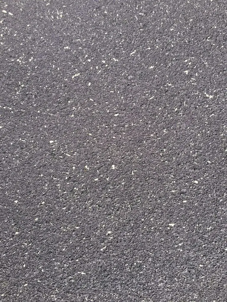 Close-up texture of a charcoal base coat with white fleck