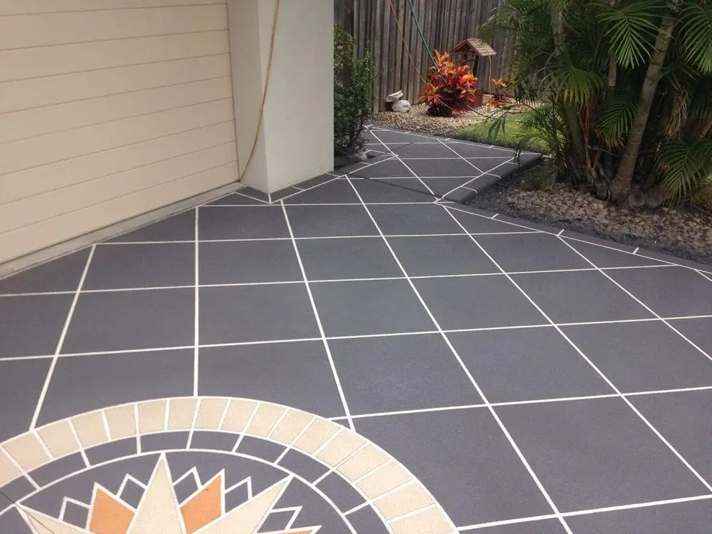 Charcoal tile-pattern driveway and garden path with a compass rose feature