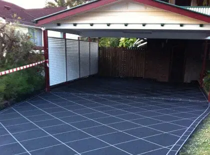 Charcoal tile-stencilled concrete carport floor