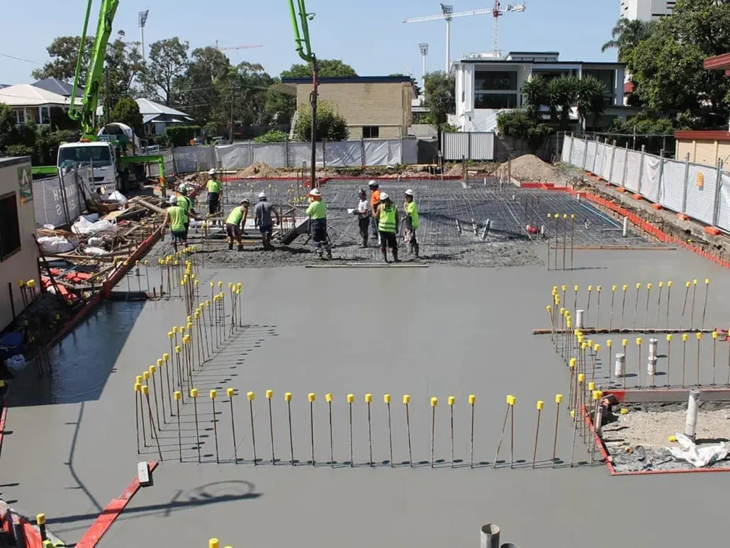 Concrete crew placing a large commercial slab with a line pump