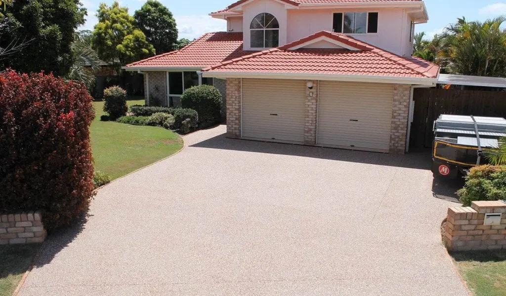 Exposed aggregate concrete driveway leading to a double garage on the Gold Coast