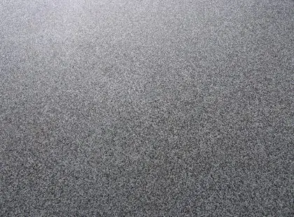 Close-up of a speckled grey flake epoxy garage floor