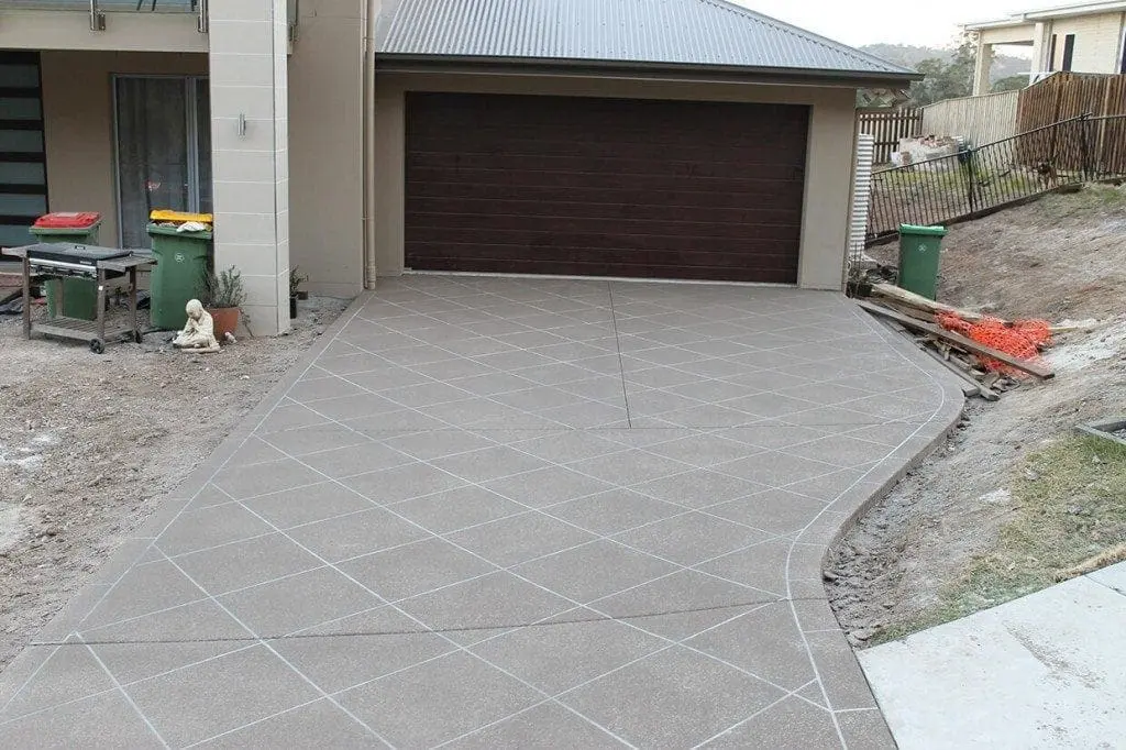 Grey diamond-tile stencilled driveway at a new home