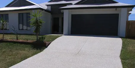Light-toned exposed aggregate driveway at a new home