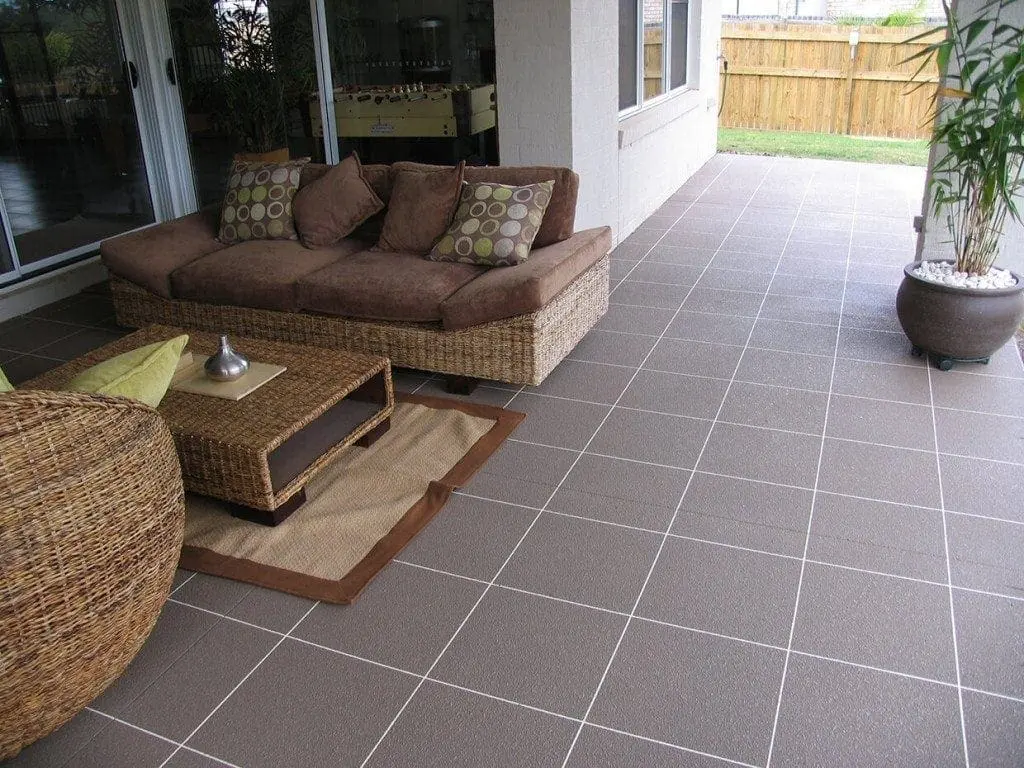 Covered alfresco area resurfaced in mocha tiles with white grout