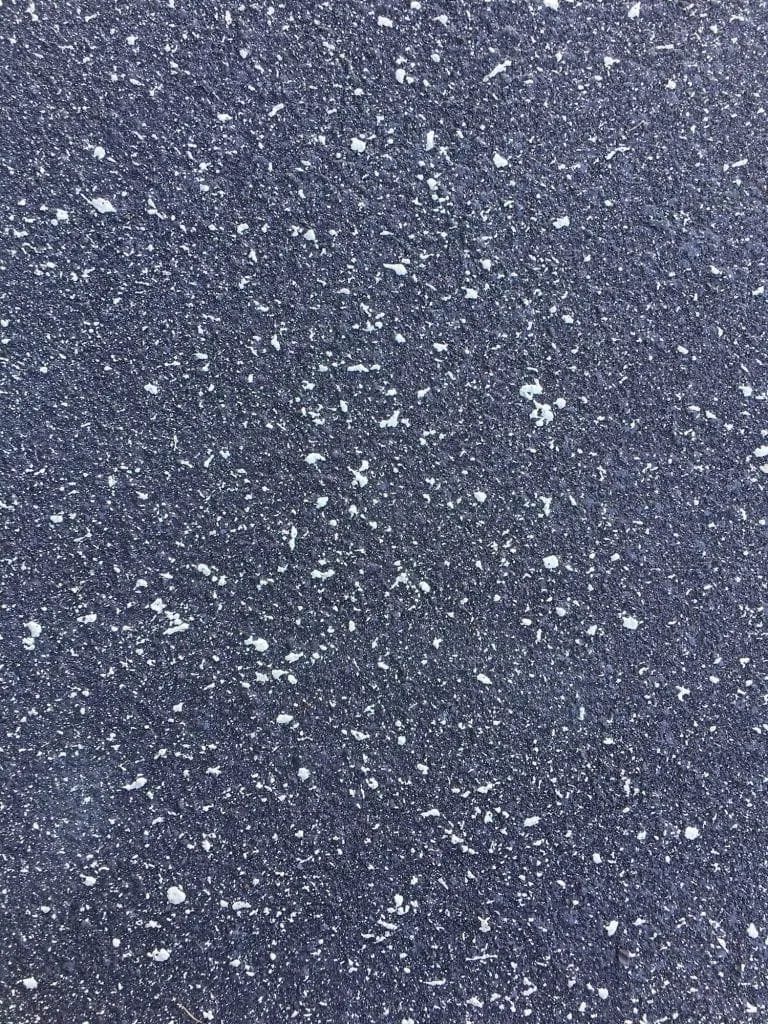 Close-up texture of a navy fleck concrete resurfacing coat