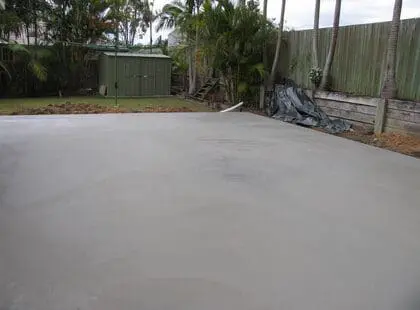 Large plain concrete shed slab in a backyard