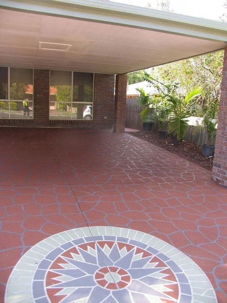 Carport resurfaced in red crazy pave with a compass rosette