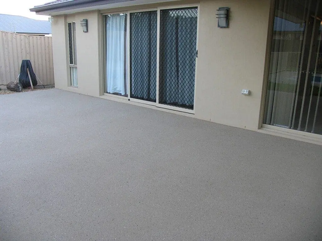 Rear patio resurfaced in a soft grey speckle finish