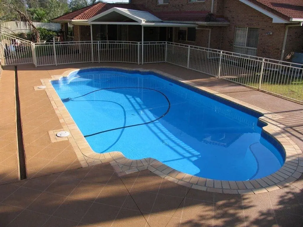 Pool surround resurfaced in a warm terracotta tile pattern