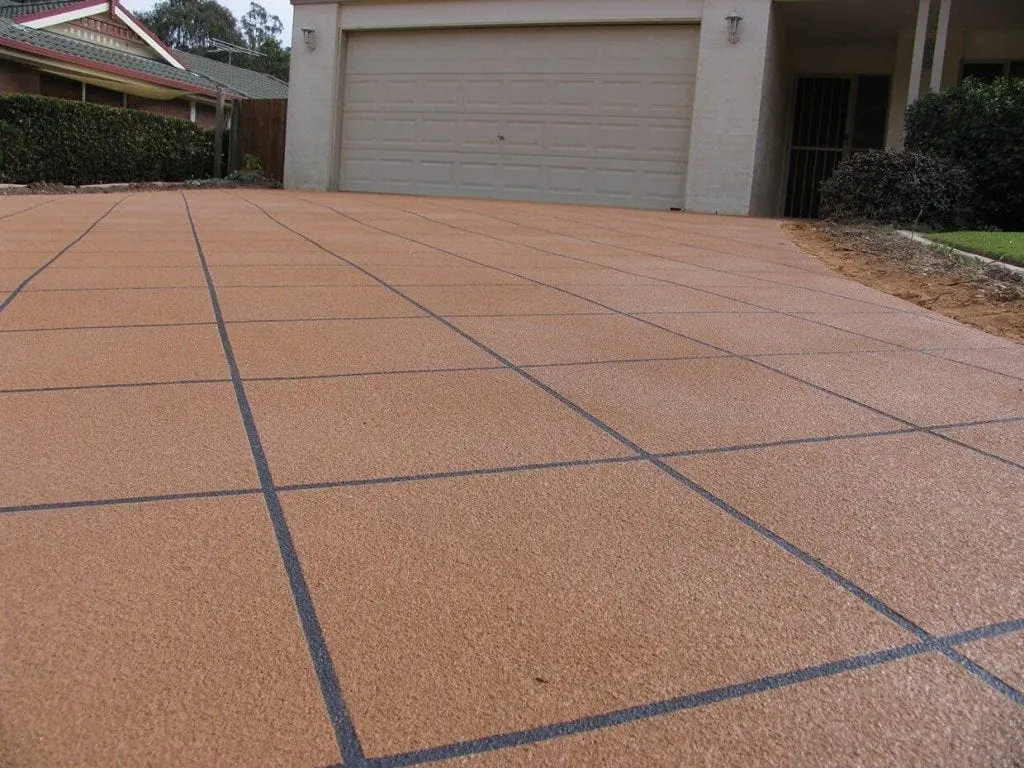 Close view of a terracotta tile-pattern driveway resurfacing with charcoal grout lines