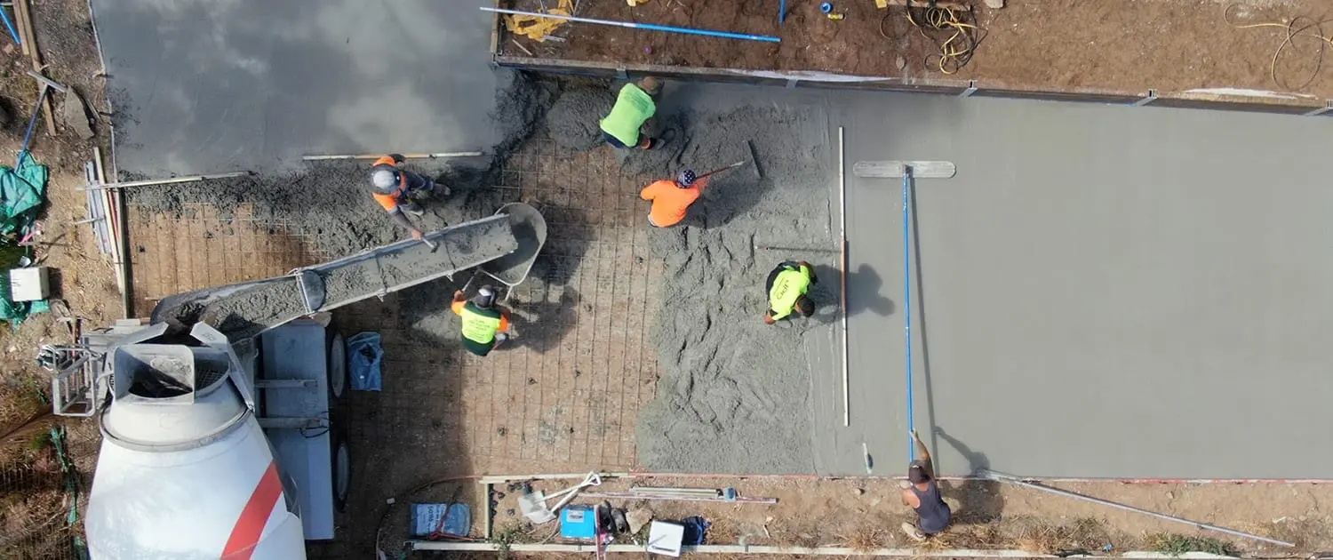 Concrete crew pouring a reinforced slab on the Gold Coast